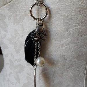 Long silver pendant necklace.